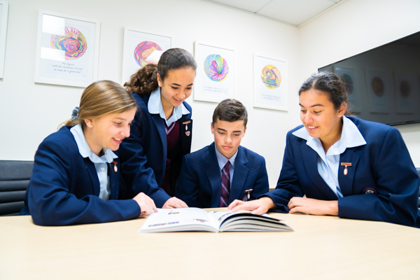 St Patrick's College Sutherland - students looking at a book